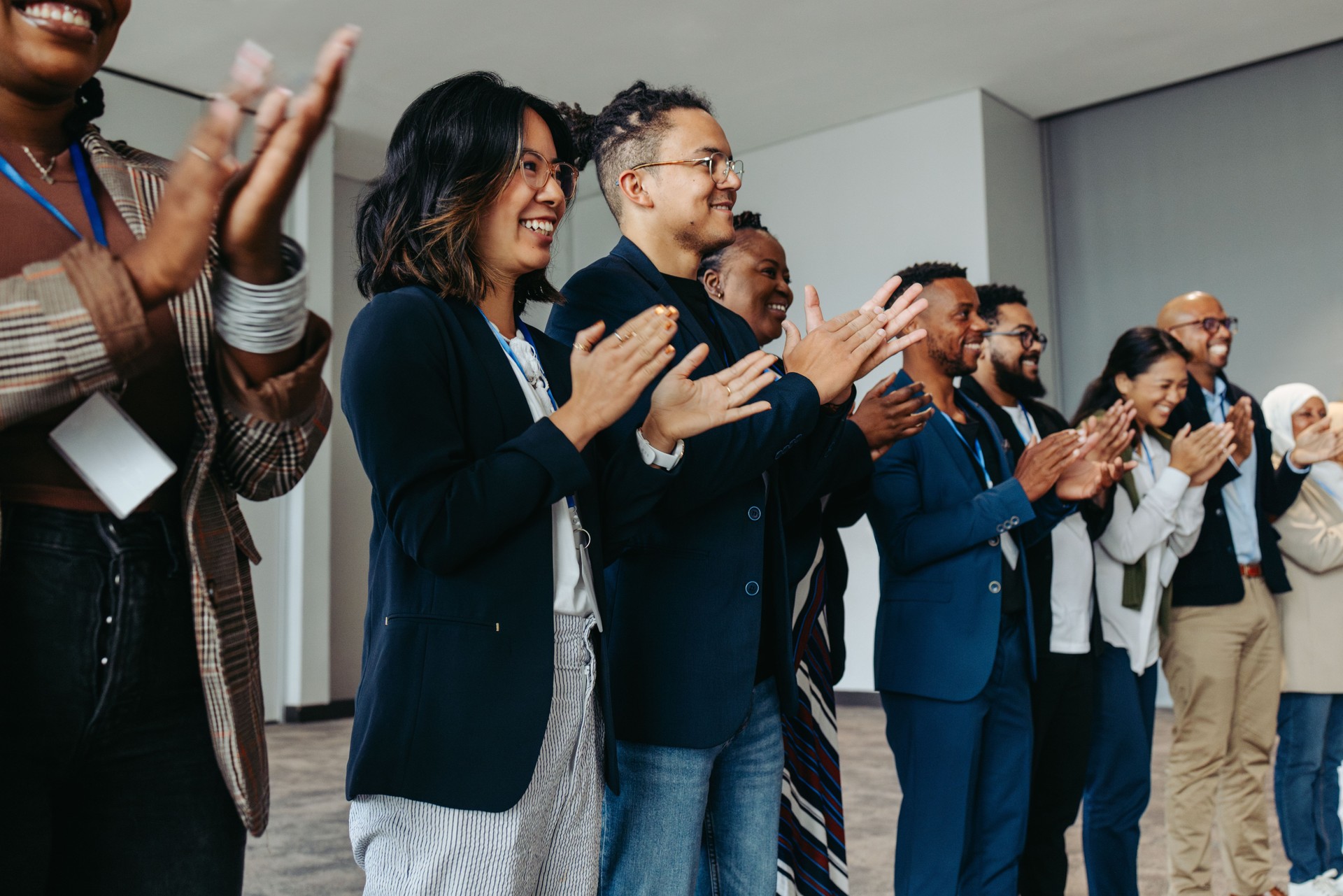 Diverse group of business employees applauding during a celebration event